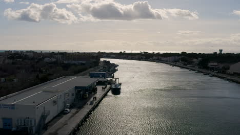 Auction-fish-market-Graud-d'Agde-port-aerial-drone-view-sunny-day-Herault-river